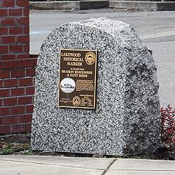 The Bradley Blockhouse & Flett House marker sits in front of the gas station whose construction required the moving of Flett House.