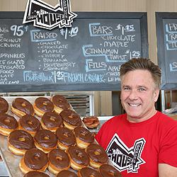 Tom Peterson with a tray of House of Donuts' finest.