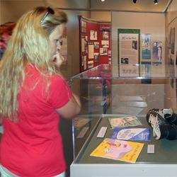 A visitor ponders artifacts from The Ice Capers, the big show held annually at the old Lakewood Ice Arena.