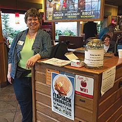 Past President Becky Huber, ready to greet yet more hungry customers.