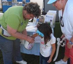 A young volunteer draws the winning ticket for our Hawaii raffle.